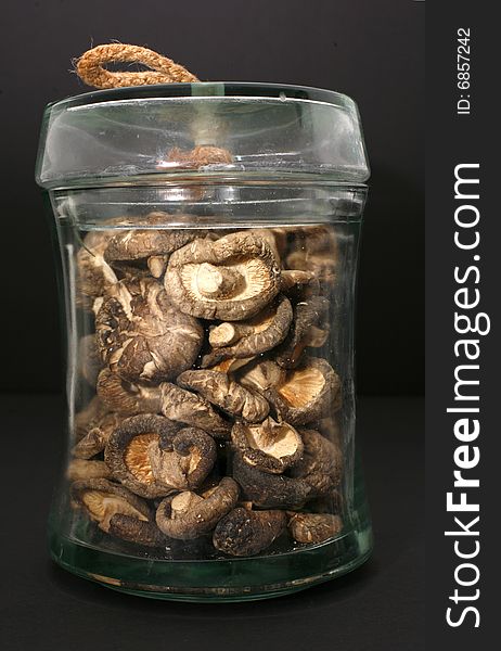 Display of dried shitake mushroom in transparent glass jar