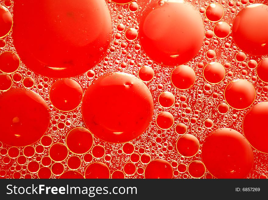 Abstract red looking oil and water bubbles of various sizes