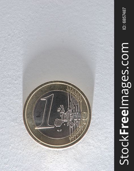 Euro coin on white paper with shadow. Euro coin on white paper with shadow