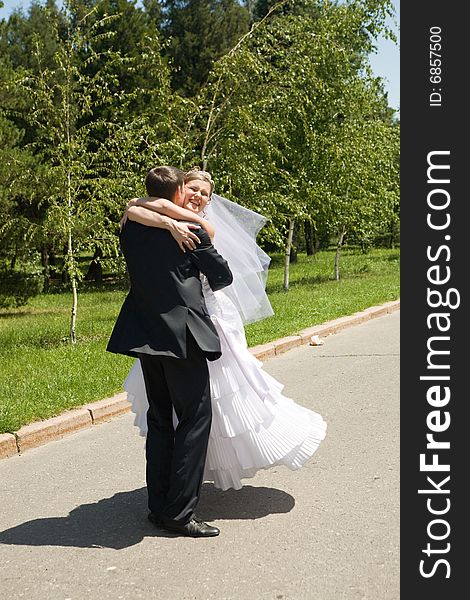 Groom turning his bride on the road. Groom turning his bride on the road