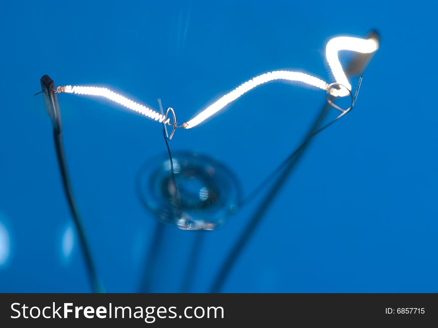 Blue electric bulb with bright filament inside. Blue electric bulb with bright filament inside