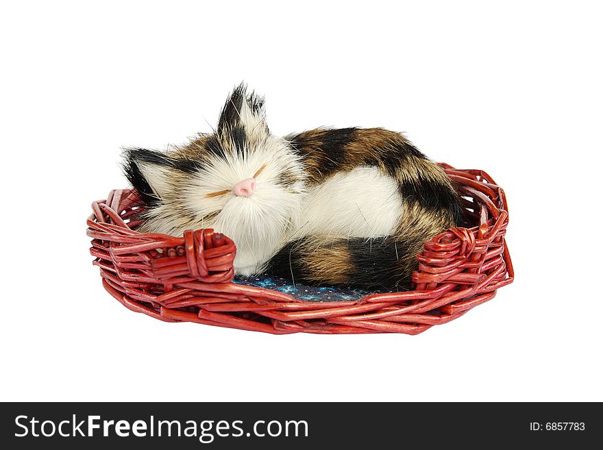 Small artificial cat sleeping in a basket. Small artificial cat sleeping in a basket