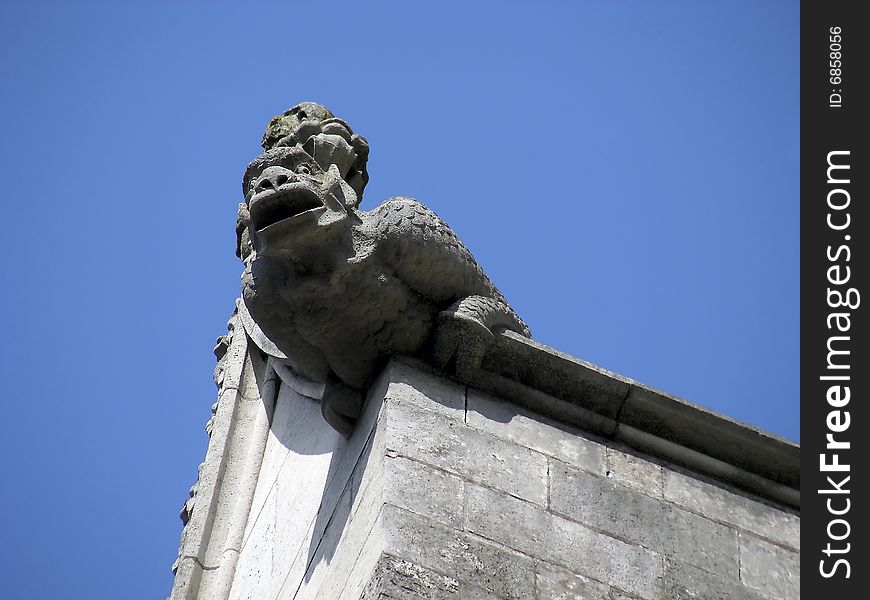Fierce looking gargoyle on the side of the cathedral at Winchester, England. Fierce looking gargoyle on the side of the cathedral at Winchester, England.