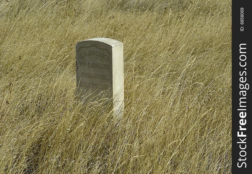 A gravestone amidst the prairie grass of Wounded Knee, Wyoming.