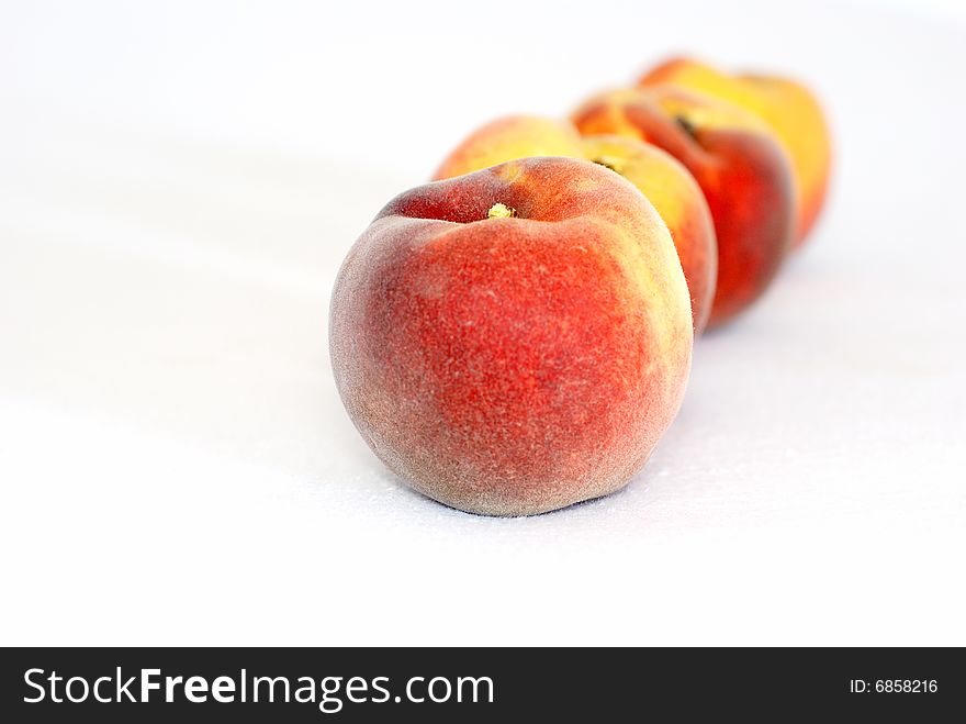 Fresh peaches on the white background