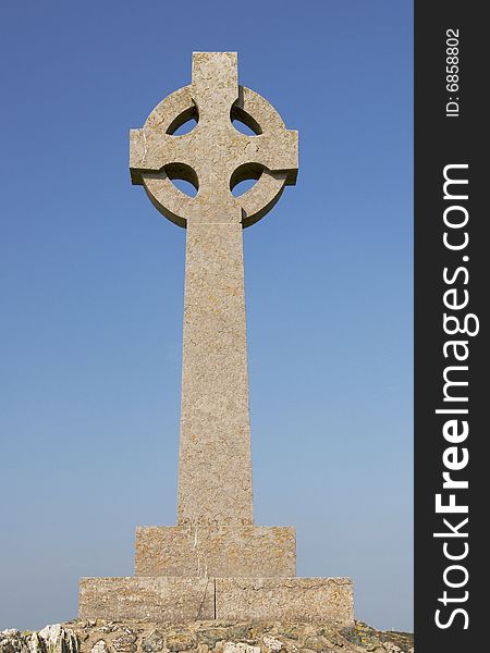 A welsh celtic cross with a blue sky. A welsh celtic cross with a blue sky