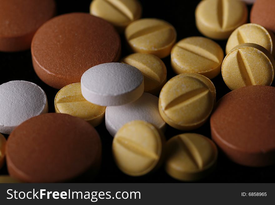 Close up on mixede pills with black background. Close up on mixede pills with black background.