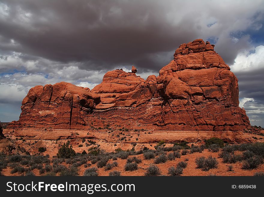 View of the red rock formations in Arches National Park with blue skyï¿½s and clouds. View of the red rock formations in Arches National Park with blue skyï¿½s and clouds