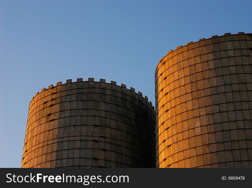 A pair of vintage grain silos at sunset. A pair of vintage grain silos at sunset