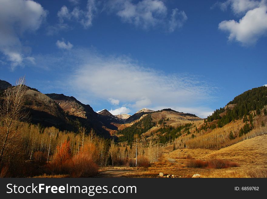 Mountain meadow in the late fall with blue sky and clouds. Mountain meadow in the late fall with blue sky and clouds