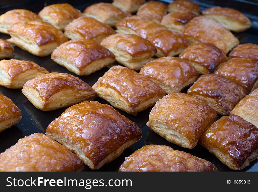 Fresh cookies just from an oven on a black sheet