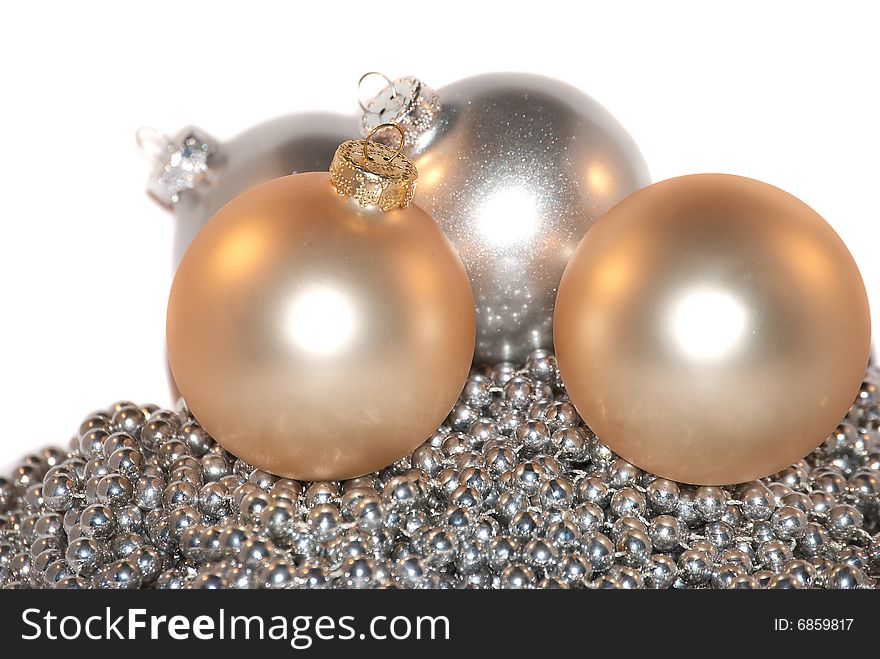 4 gold and silver Christmas ornament isolateв on the metallic beads. 4 gold and silver Christmas ornament isolateв on the metallic beads.