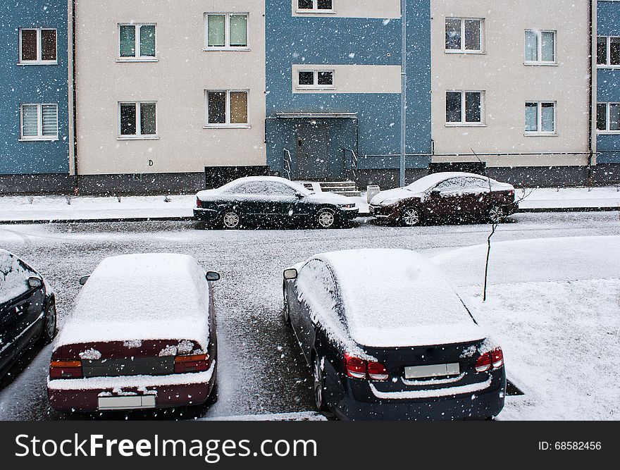 Four cars parked near the house in the snow on winter day. Four cars parked near the house in the snow on winter day