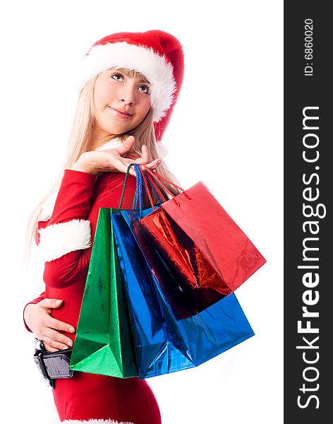Dreamy girl dressed as Santa with shopping bags. Dreamy girl dressed as Santa with shopping bags