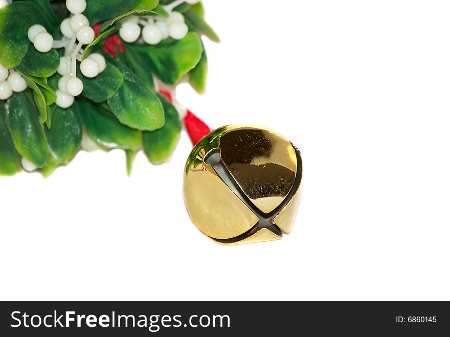 Christmas jingle bell with green leafs isolated on the white.