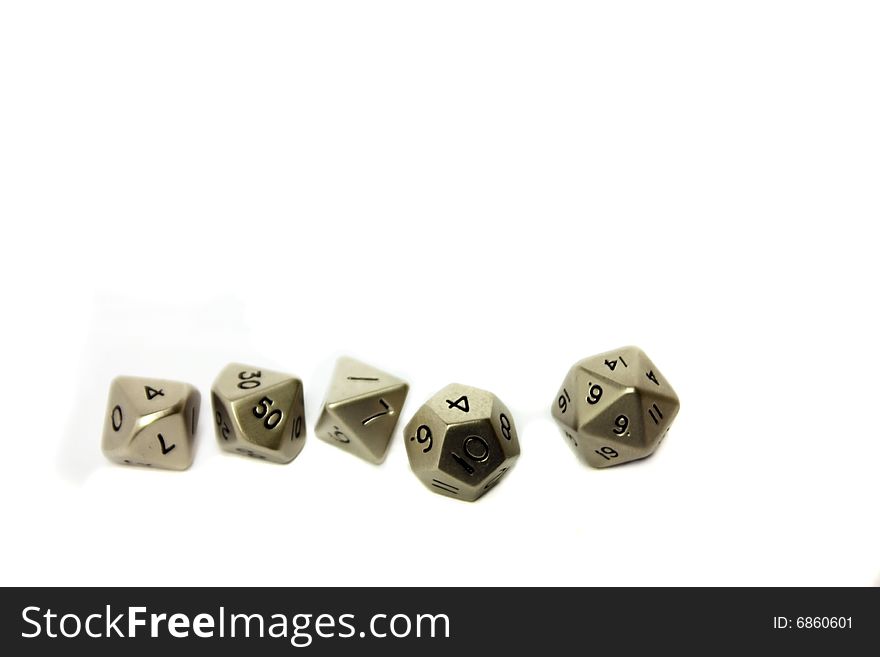 Small metal dice in a row on a white background. Copy space.