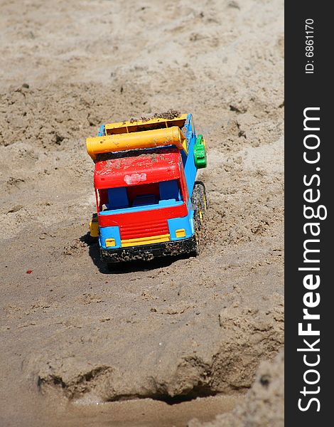 Toy car in the beach sand
