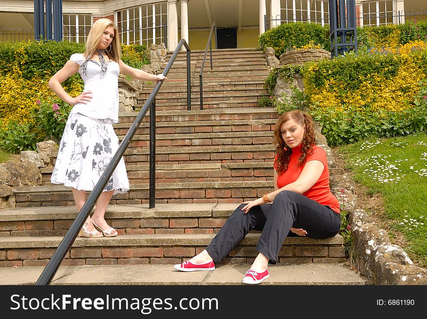 Portrait of two pretty girls, blond and redhead, outside. Portrait of two pretty girls, blond and redhead, outside