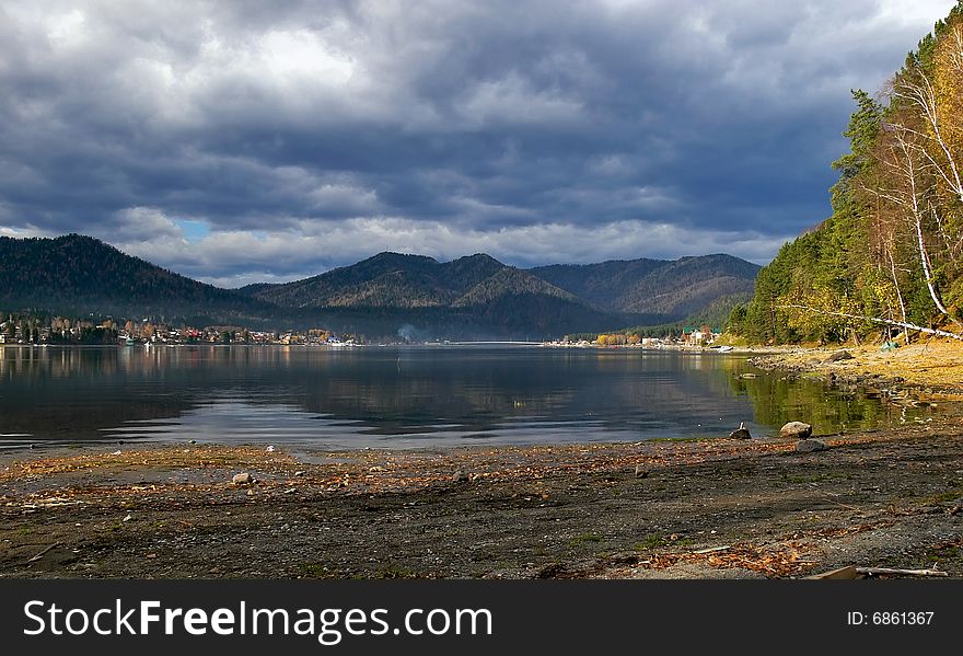 Coastline lake Teletskoe and cloudscape