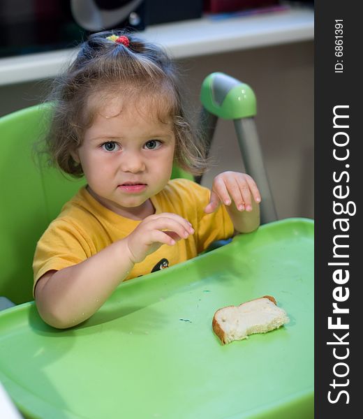 Little girl sitting at table