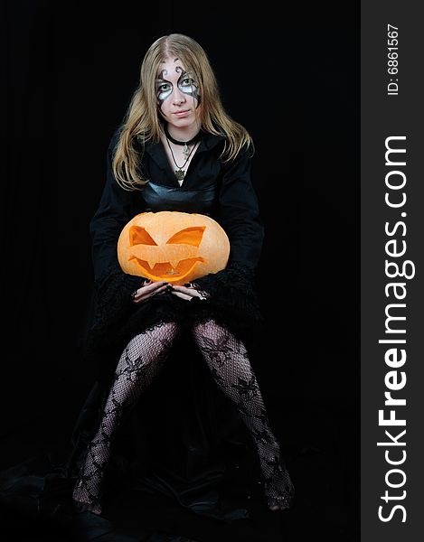 Nice girl with orange halloween pumpkin