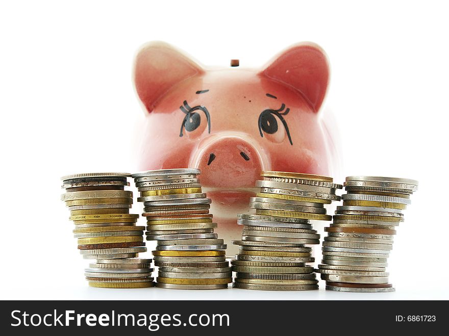 Pink piggy bank isolated on white background with coins. Pink piggy bank isolated on white background with coins