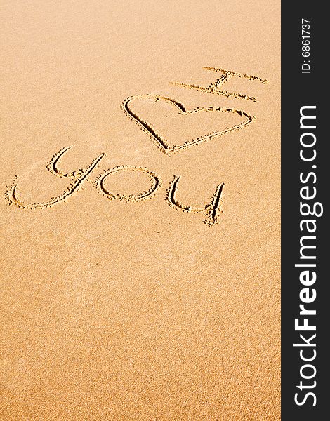 The words I love you written on the beach sand. The words I love you written on the beach sand