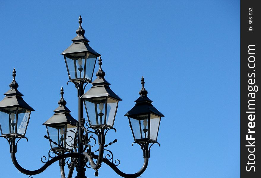 Photograph of outdoor colonial style street lamps. Photograph of outdoor colonial style street lamps.