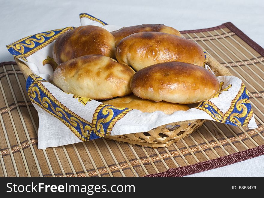 Home pies in a straw basket. Home pies in a straw basket