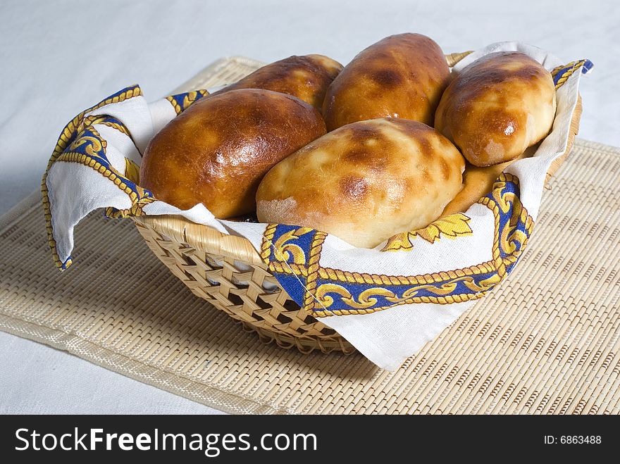 Home pies in a straw basket. Home pies in a straw basket