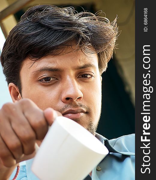 Image of a guy with a cup of tea. Image of a guy with a cup of tea