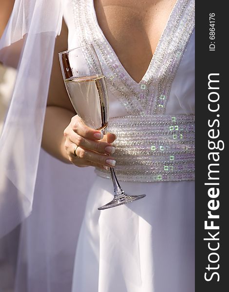 Bride with wine glass during wedding celebrations