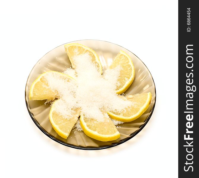 Lemon slices and sugar on plate