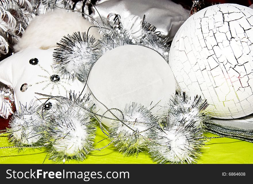White and silver  christmas decoration on green forground