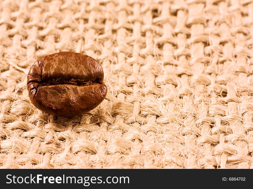 Coffee bean isolated on a jute background. Coffee bean isolated on a jute background