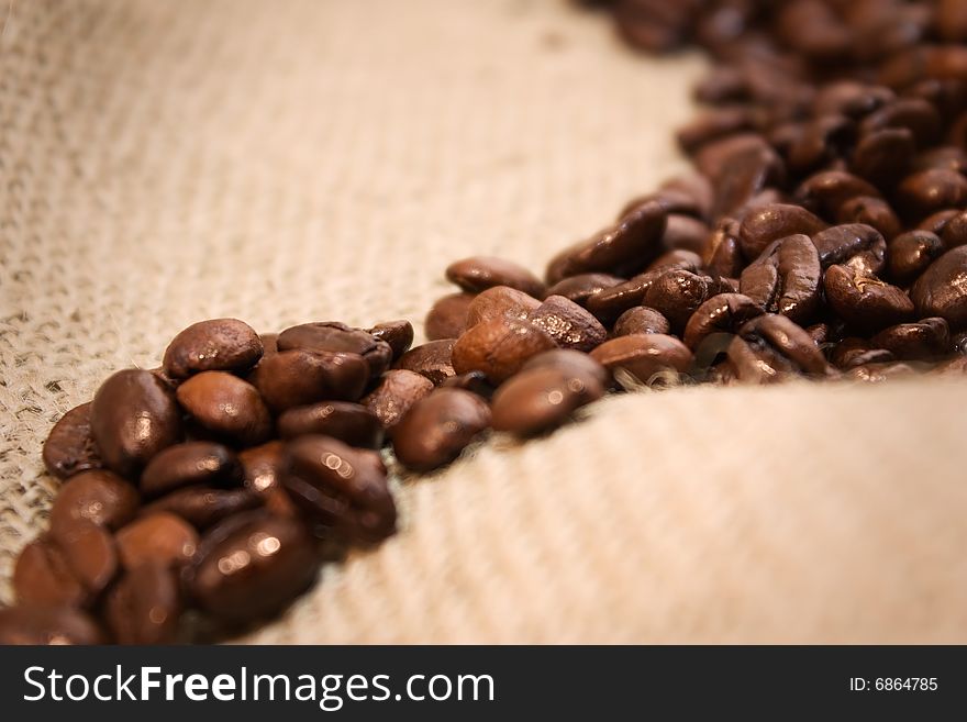 Coffee beans isolated  on a jute background. Coffee beans isolated  on a jute background