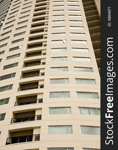 A high rise condominium tower with balconies and windows. A high rise condominium tower with balconies and windows