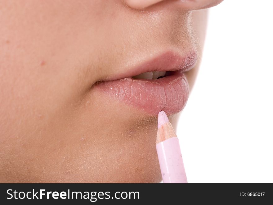 Girl drawing a lip line with pink pencil