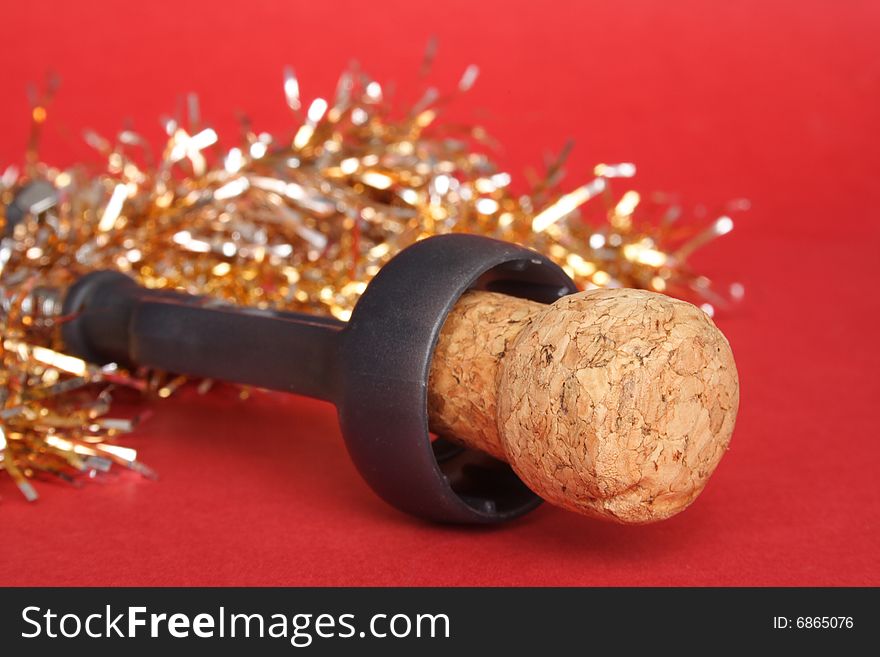 Champagne cork and decorations in red background. Champagne cork and decorations in red background