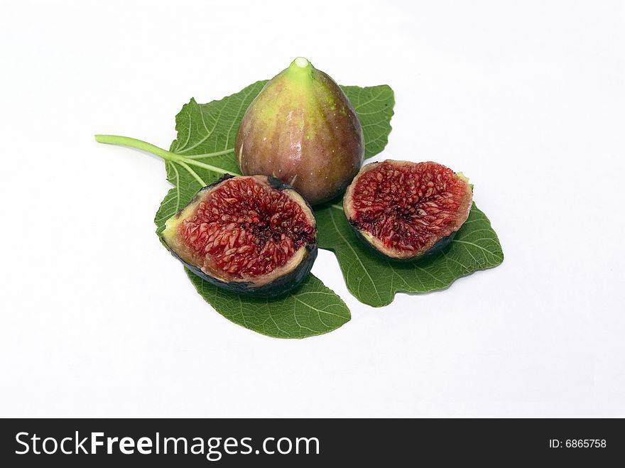 Isolated fig berries with green fig leaf on white background. Isolated fig berries with green fig leaf on white background