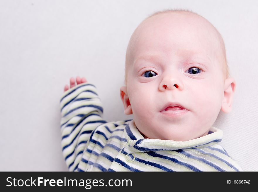 Newborn baby over light background