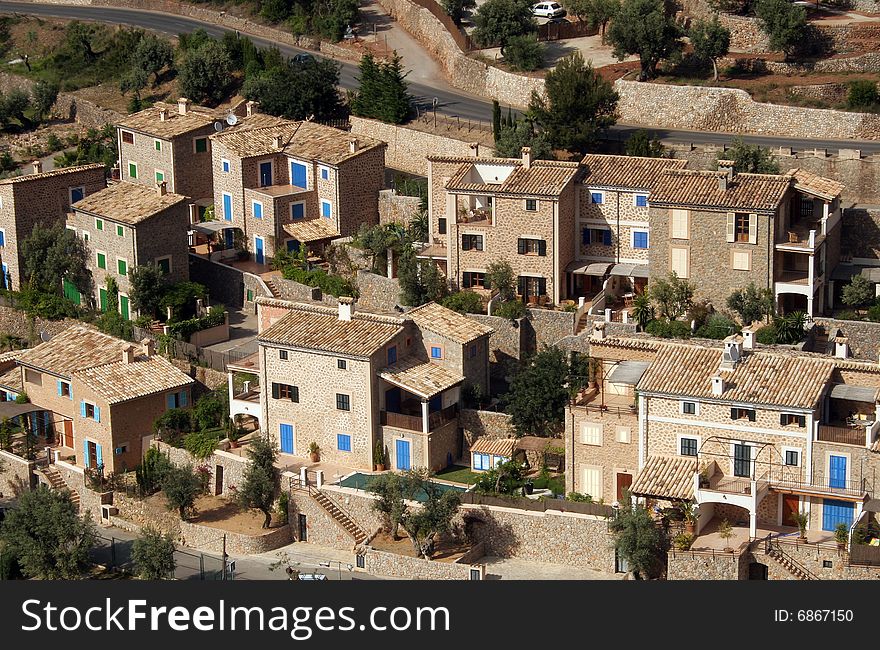 Stone houses with blue shutters in a village in Majorca in Spain. Stone houses with blue shutters in a village in Majorca in Spain