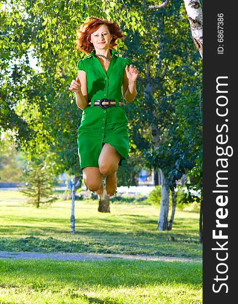 Young beautiful woman jumps with happiness