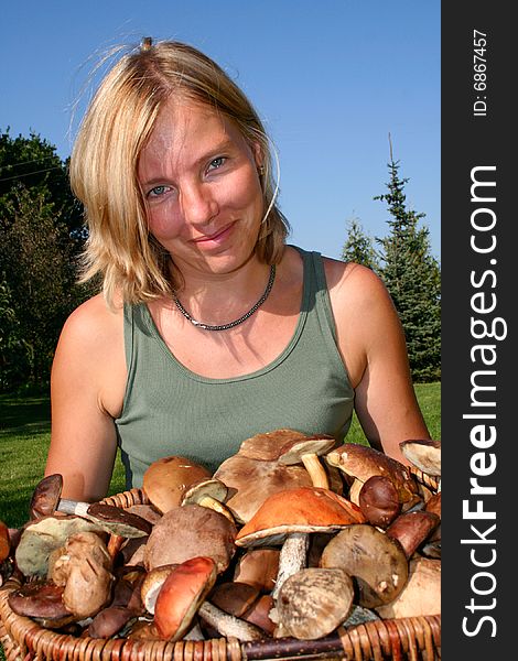 Woman with big basket full of mushrooms