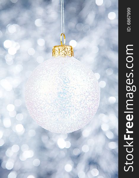 White Christmas-tree decoration on a silvery background