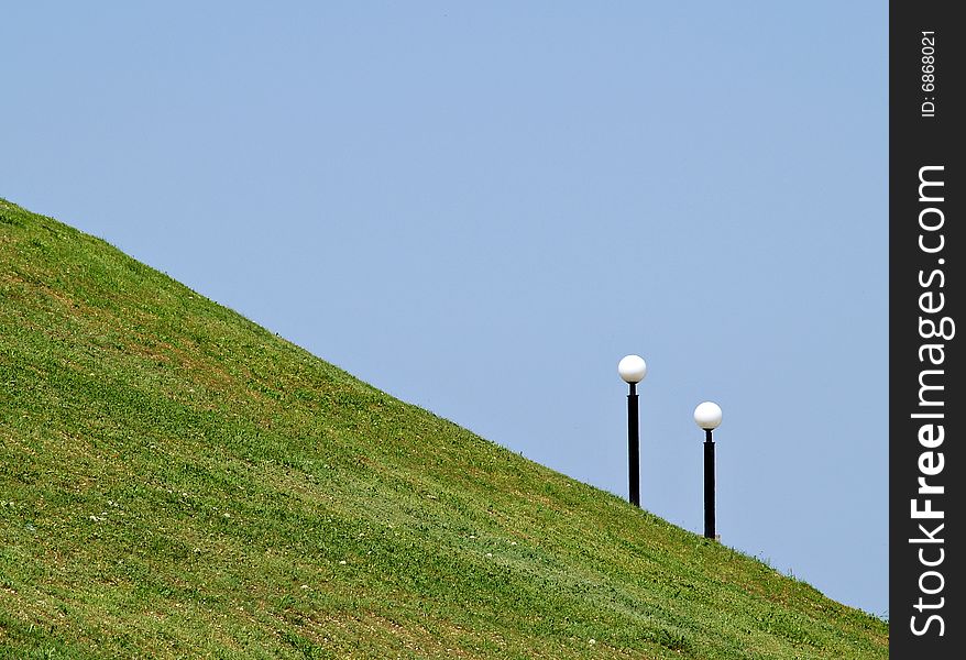 Two lights on green hill