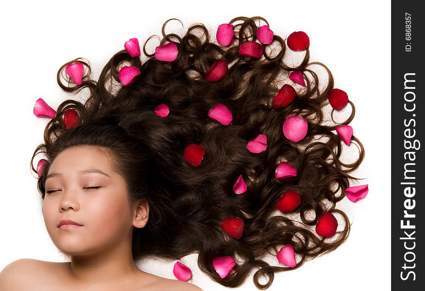 Asian girl with long hair and rose petals