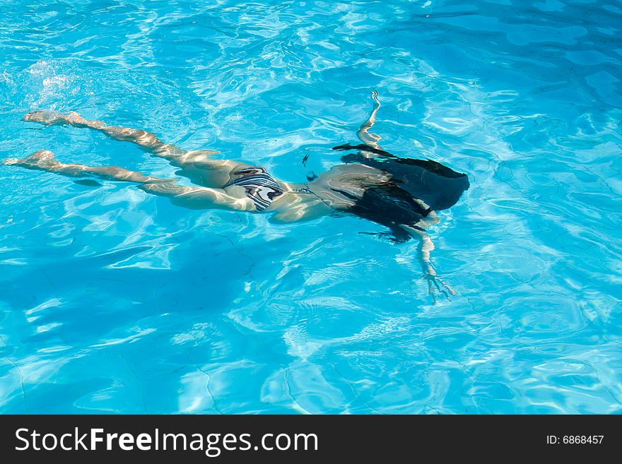 Woman underwater in swimming pool. Woman underwater in swimming pool