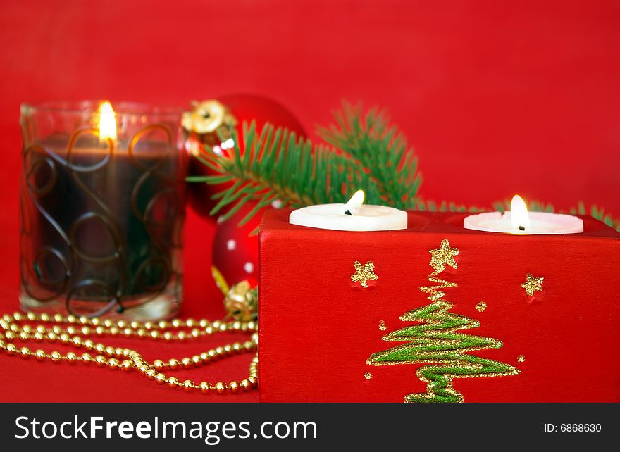 Christmas card. Candle and decoration isolated on red. Christmas card. Candle and decoration isolated on red