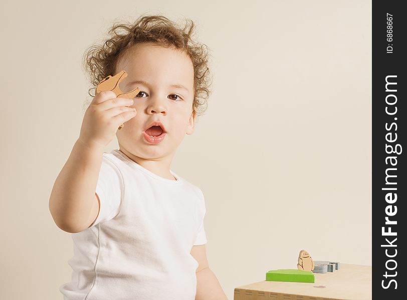 Small Boy Holding A Toy